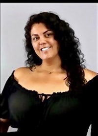 a woman in a black top posing for a picture